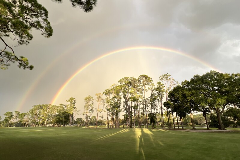 Double rainbow over Deerwood's tree-lined fairways